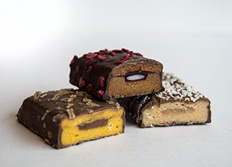 Protein bars manufactured with fillings and topping